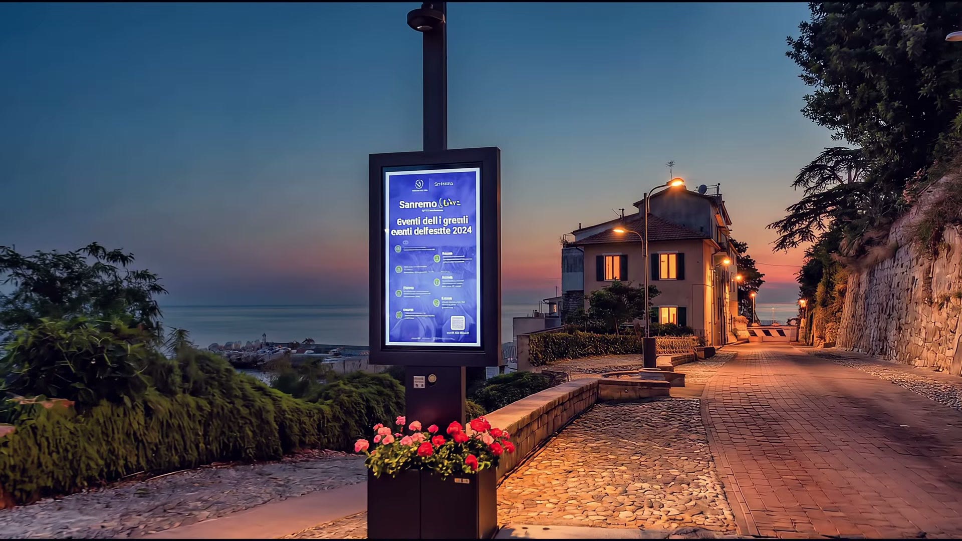 Isola smart con display e fioriera nella Pigna di Sanremo al tramonto, con il mare sullo sfondo